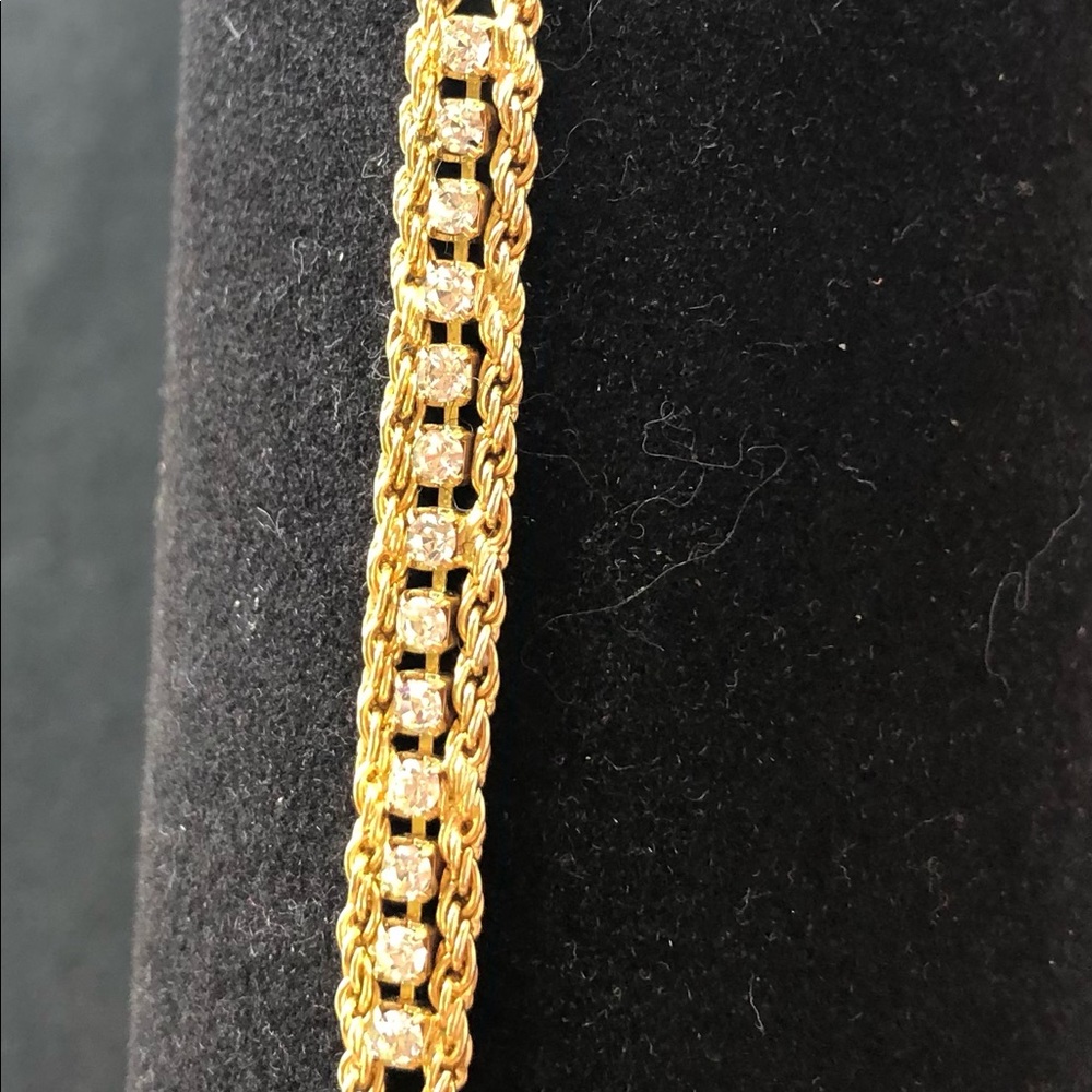 Gold tone tennis style bracelet with CZ stones.